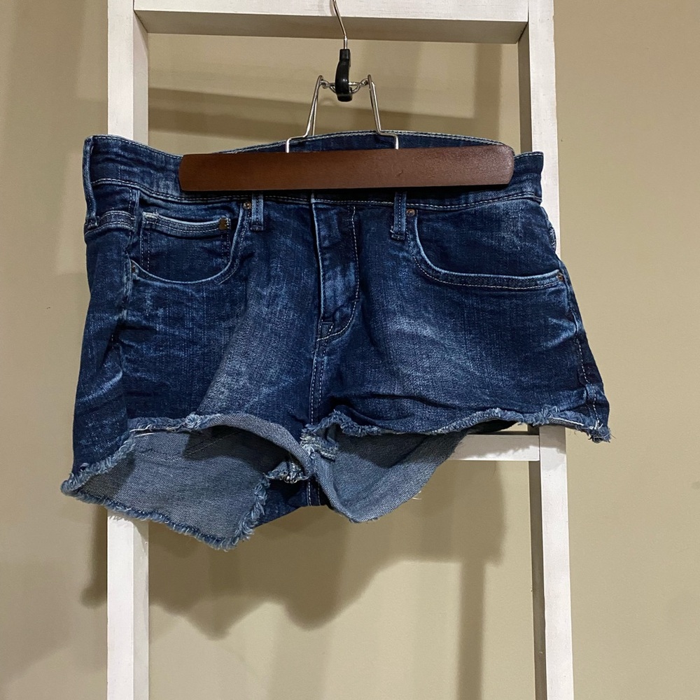 The H&M Shorts, dark blue denim cutoff,raw hem and a high rise. Womens size 6